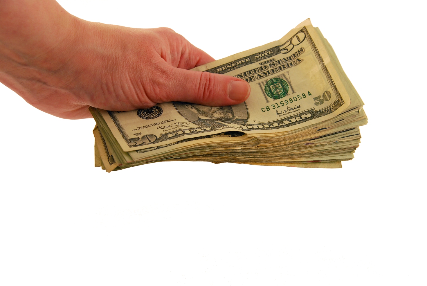 Money in hand in the form of many large bills